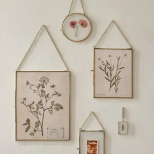 Josie Hanging Brass Photo Frames shown on wall