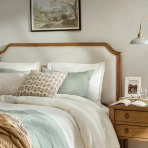 Corinne Upholstered Bed with bedding in a bedroom